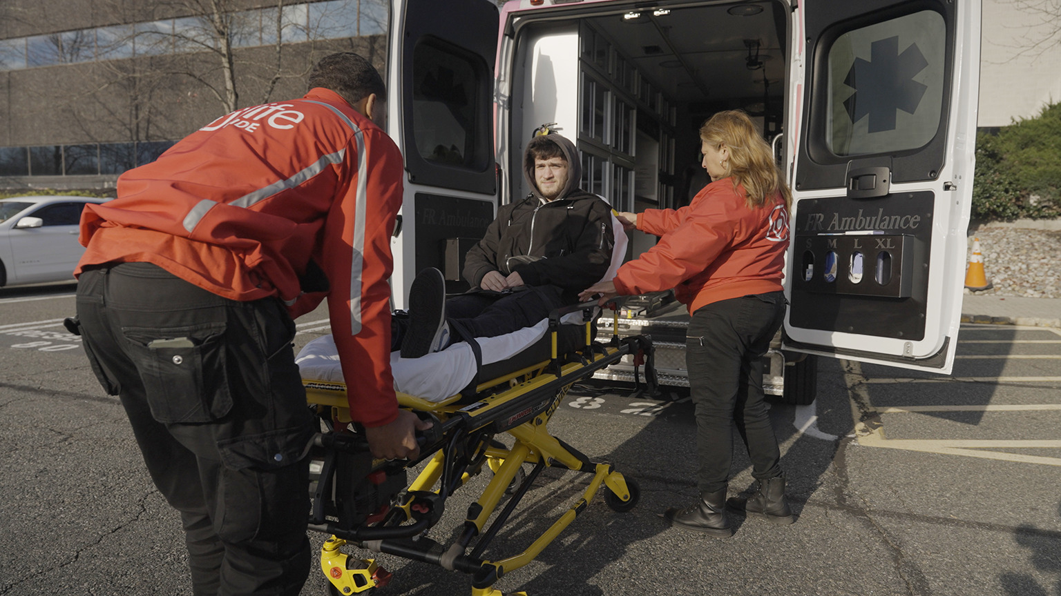 emt staff taking patient to ambulance